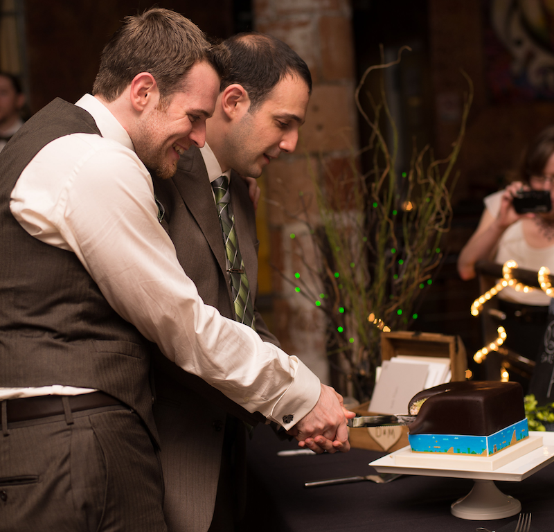 Razavi and his husband cutting their wedding cake